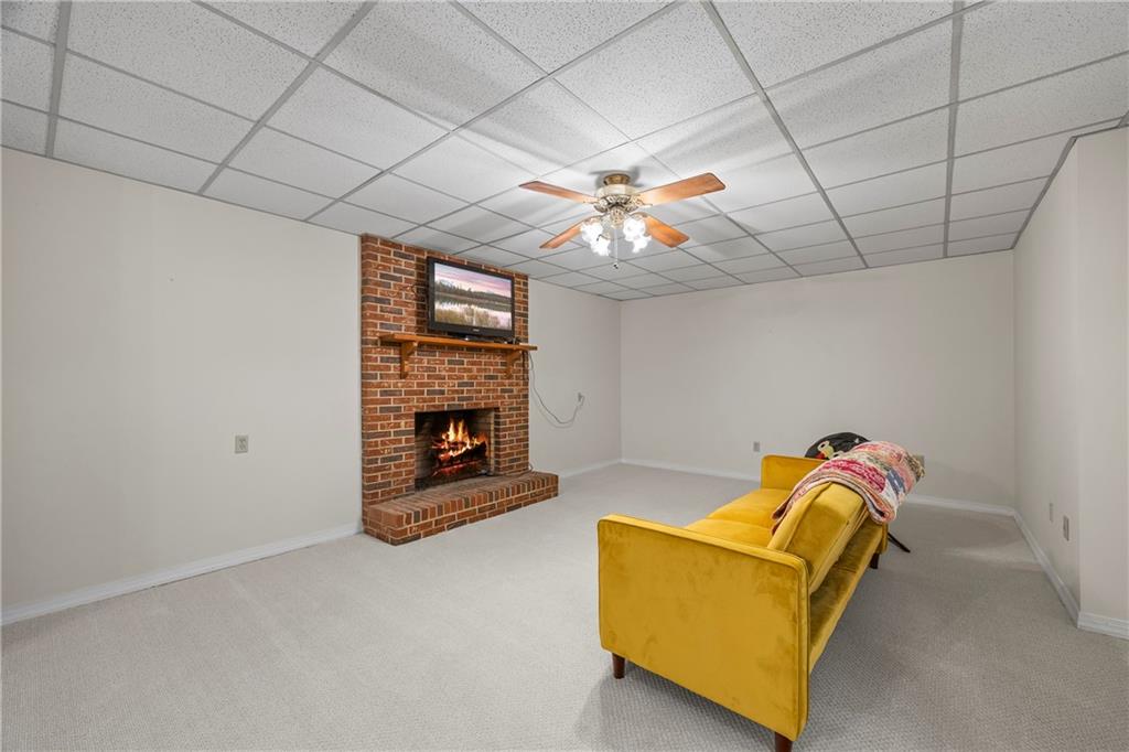 750 Staghorn Trail Nicholson, GA 30565 - Photo 20 of 41 a living room with furniture a fireplace and a chandelier