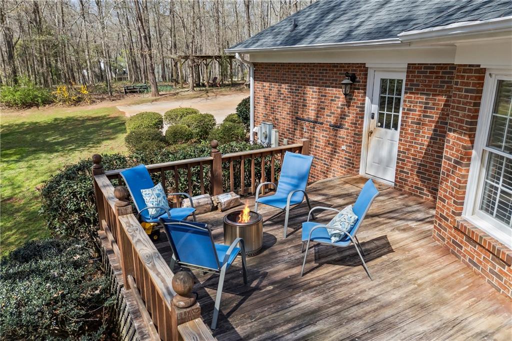 750 Staghorn Trail Nicholson, GA 30565 - Photo 26 of 41 a view of a deck with table and chairs with wooden floor and fence