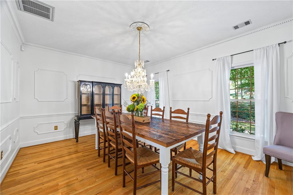 750 Staghorn Trail Nicholson, GA 30565 - Photo 4 of 41 a dining room with furniture a chandelier and wooden floor