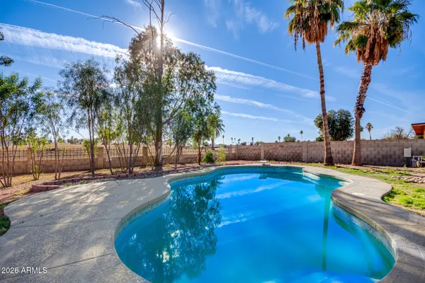 a view of a swimming pool with a yard