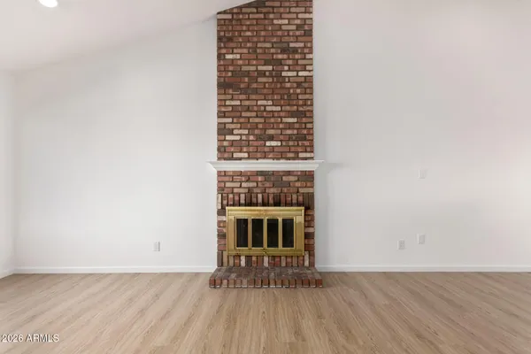 a view of a room with wooden floor a sink and a window