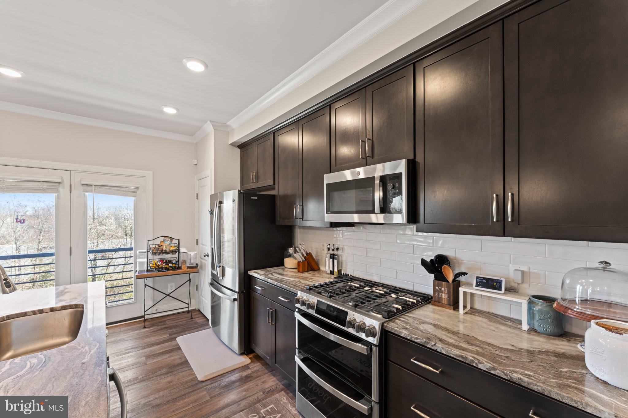 1330 Rail Woodbridge, VA 22191 - Photo 11 of 28 a kitchen with granite countertop stainless steel appliances and wooden cabinets