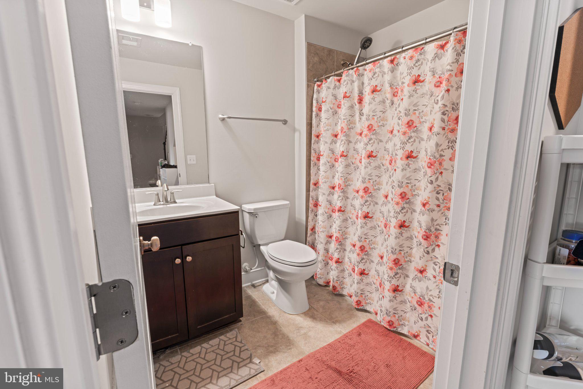 1330 Rail Woodbridge, VA 22191 - Photo 14 of 28 a bathroom with a sink a toilet and shower curtain