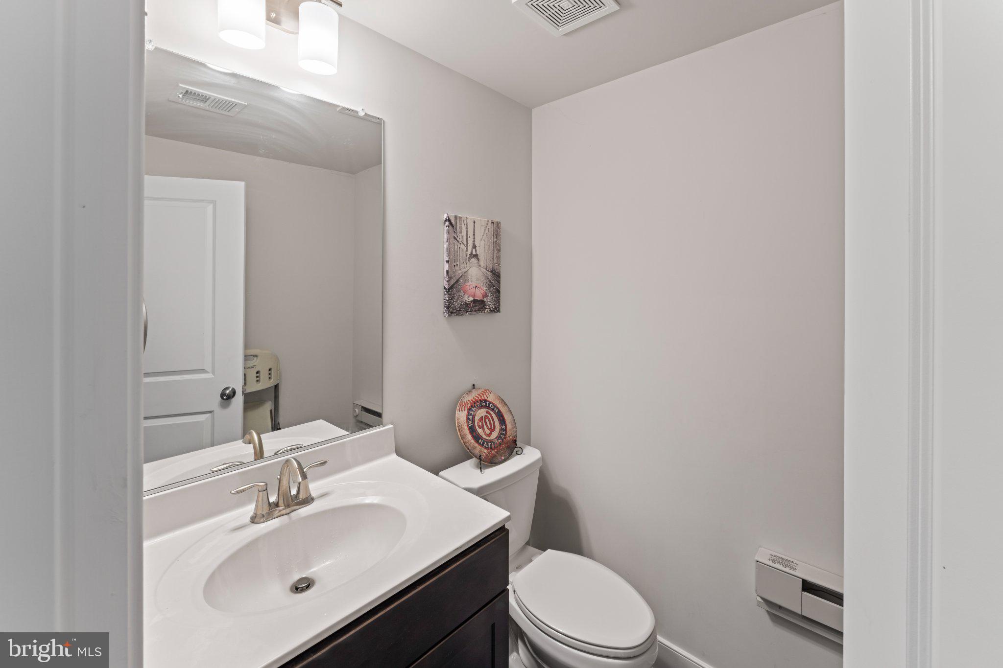 1330 Rail Woodbridge, VA 22191 - Photo 27 of 28 a bathroom with a sink mirror vanity and toilet