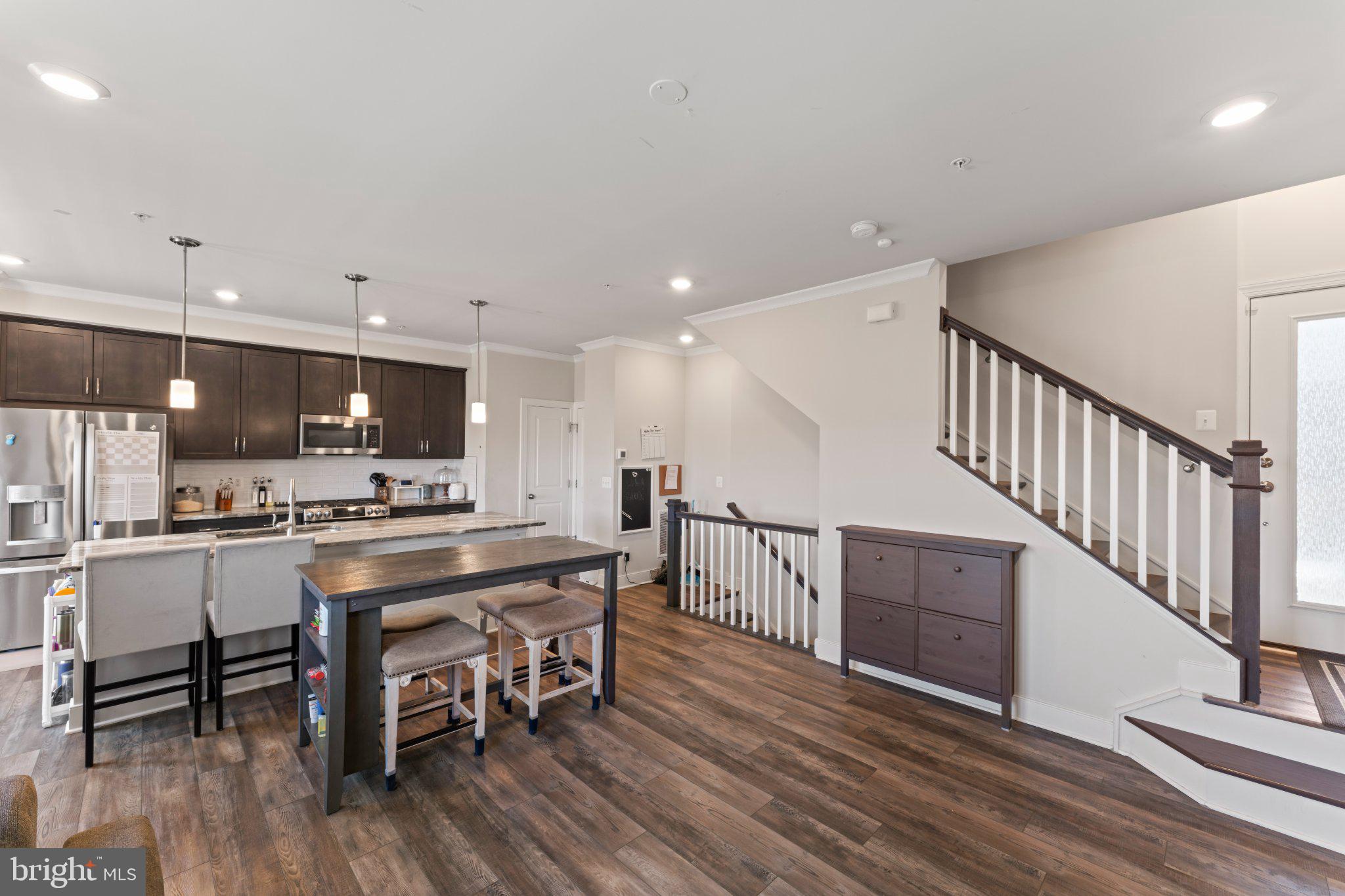 1330 Rail Woodbridge, VA 22191 - Photo 9 of 28 a kitchen with stainless steel appliances a dining table chairs and wooden floor