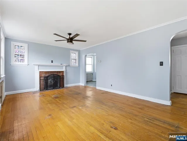 a view of a livingroom with a fireplace and a ceiling fan