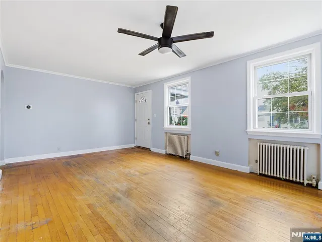 a view of room with a ceiling fan and window