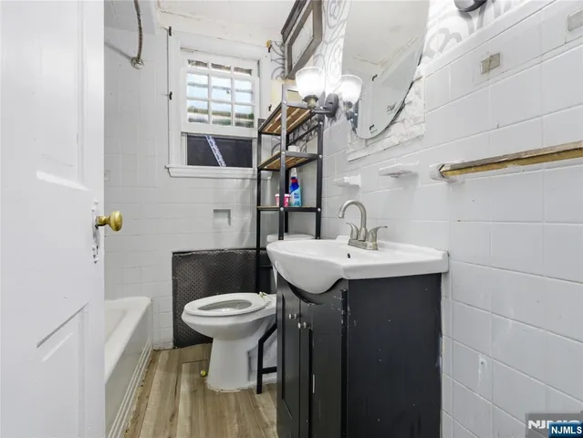 a bathroom with a sink a toilet and mirror