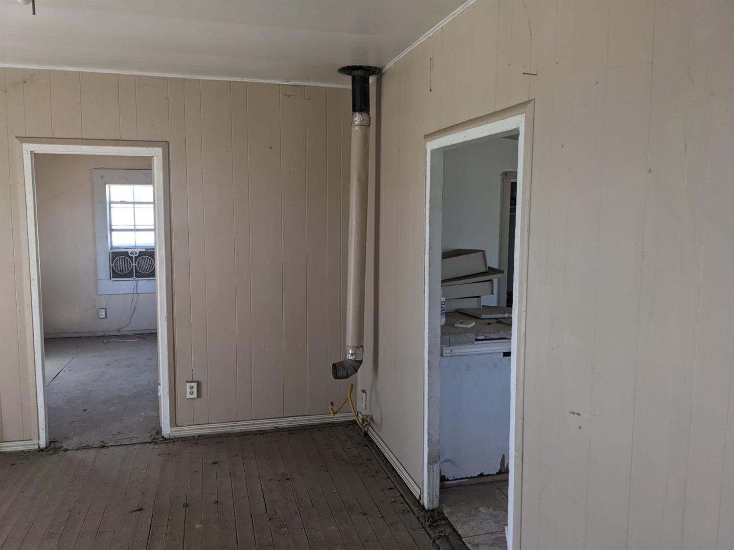26492 Harrison Road Visalia, CA 93277 - Photo 15 of 29 an empty room and a bathroom with mirror