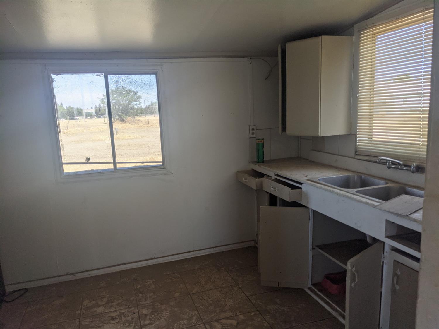 26492 Harrison Road Visalia, CA 93277 - Photo 18 of 29 a kitchen with a sink cabinets and a window