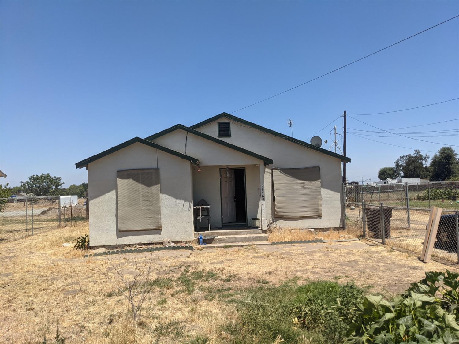 26492 Harrison Road Visalia, CA 93277 - Photo 5 of 29 a wooden house with a yard