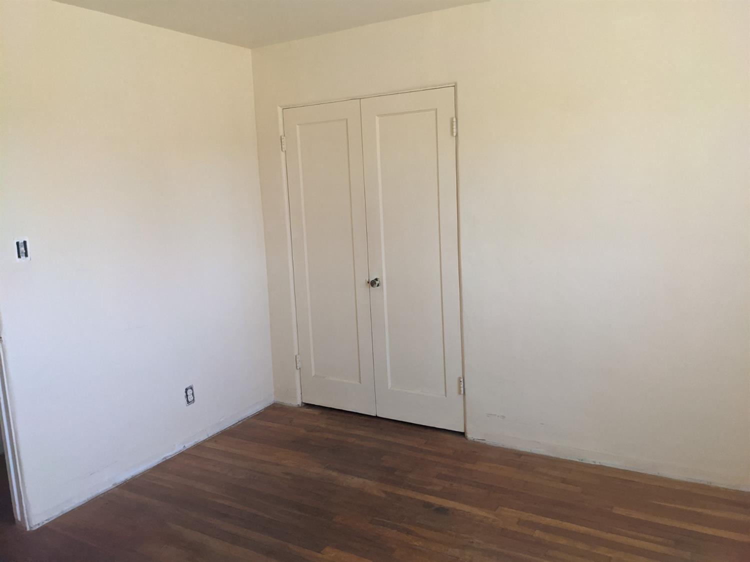 26492 Harrison Road Visalia, CA 93277 - Photo 7 of 29 a view of an empty room with wooden floor