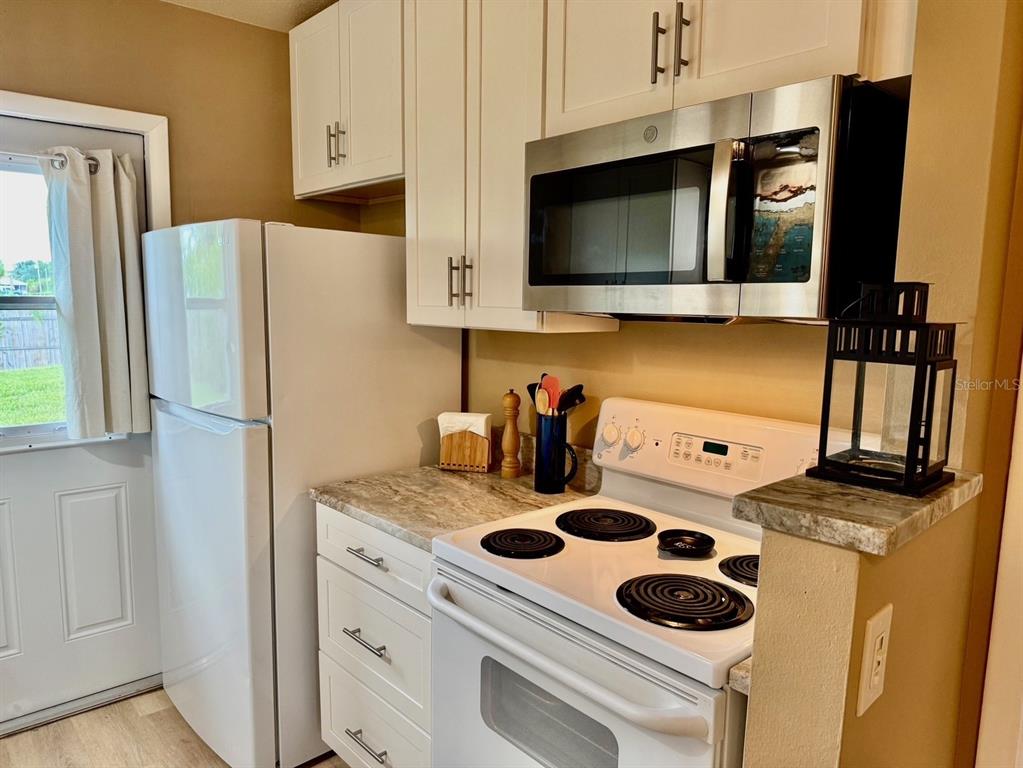 11248 Pendleton Avenue, Unit A&B Englewood, FL 34224 - Photo 11 of 15 a kitchen with a appliances and a refrigerator
