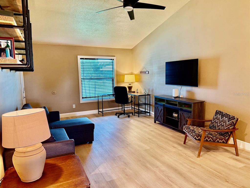 11248 Pendleton Avenue, Unit A&B Englewood, FL 34224 - Photo 2 of 15 a living room with furniture and a flat screen tv