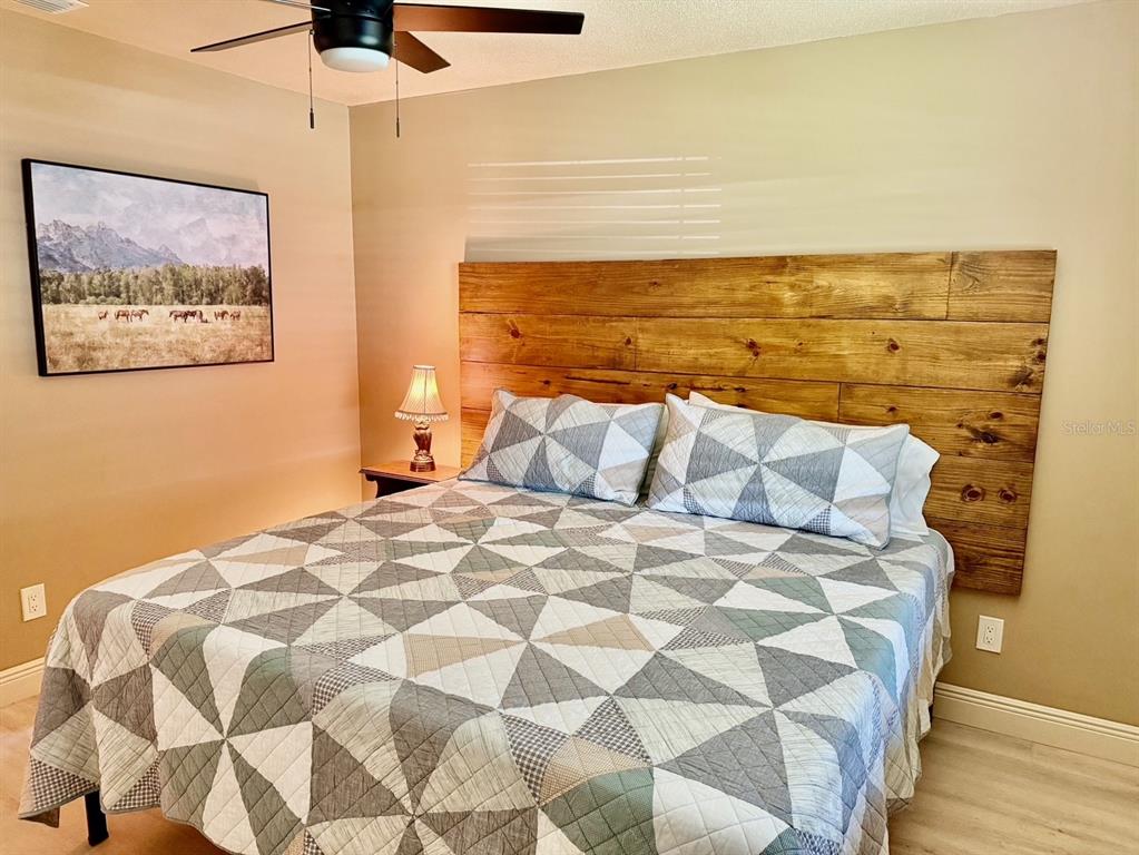 11248 Pendleton Avenue, Unit A&B Englewood, FL 34224 - Photo 5 of 15 a large bed sitting in a bedroom next to a wall