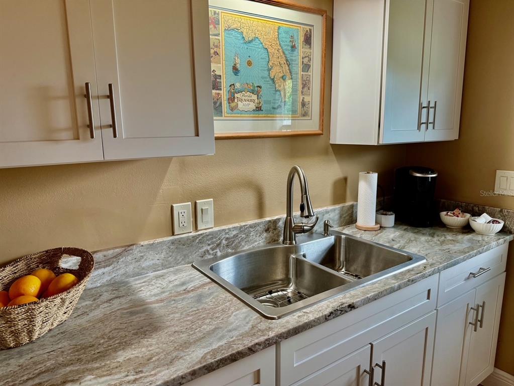 11248 Pendleton Avenue, Unit A&B Englewood, FL 34224 - Photo 8 of 15 a kitchen with stainless steel appliances granite countertop a sink a granite counter tops and a wooden cabinets