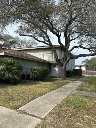 a view of a tree in front of a house