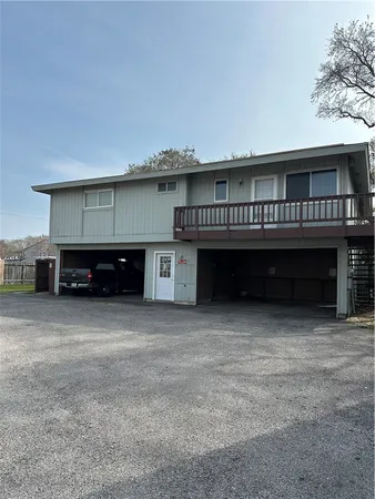 a view of a house with a balcony and car parked