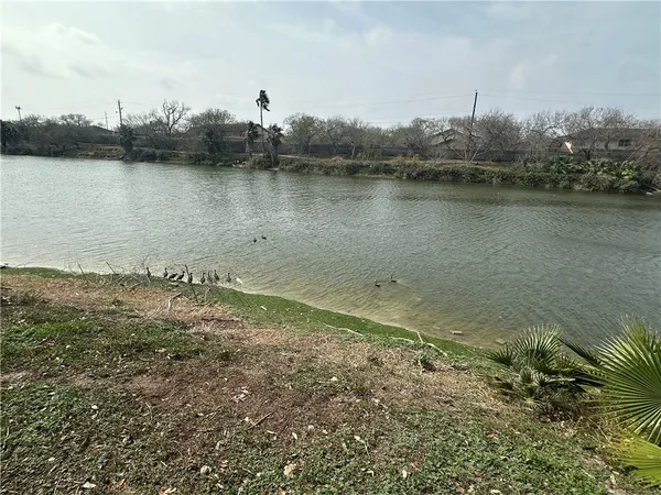 a view of a lake with houses in the background
