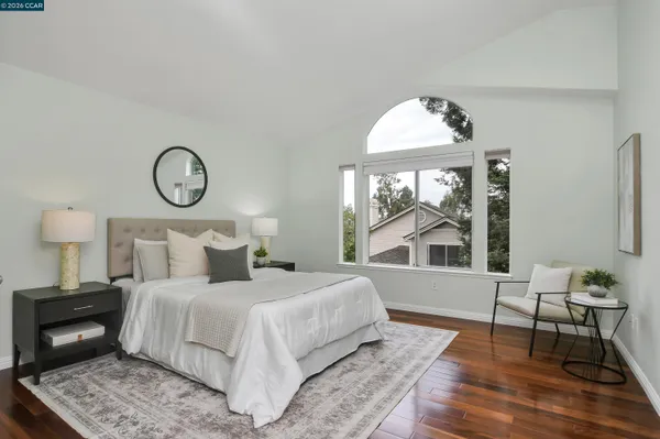 a bedroom with a large bed and a window