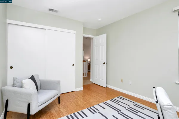 a bedroom with a bed and a couch