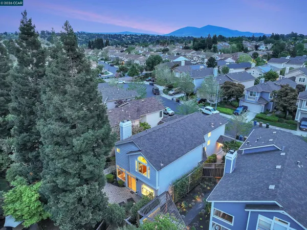 an aerial view of a house with a yard