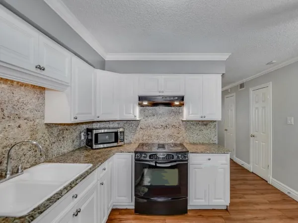 a kitchen with stainless steel appliances granite countertop a stove and a sink