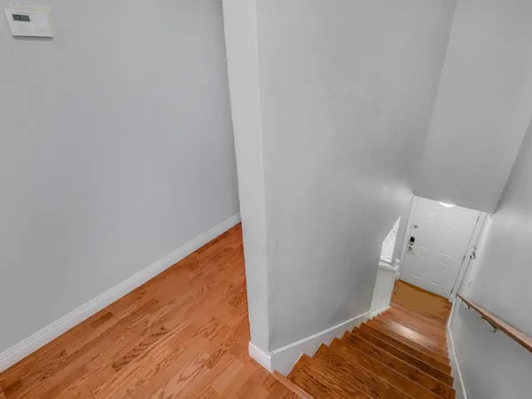 a view of a room with wooden floor