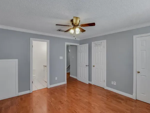 a view of a room with a ceiling fan and a window