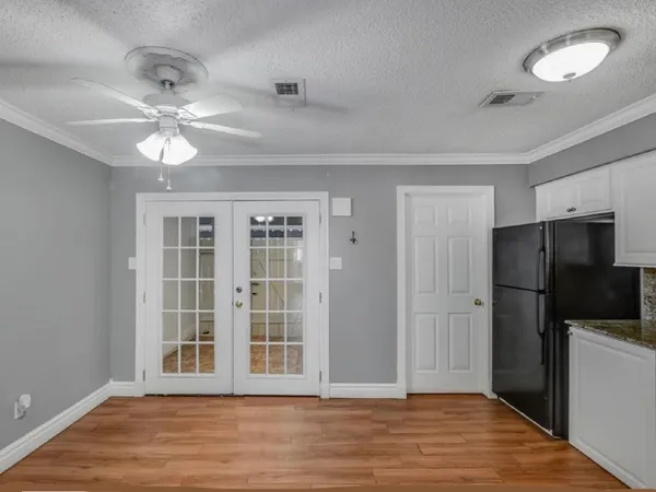 a view of an empty room with a kitchen