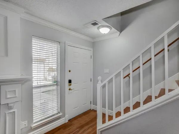 a view of staircase with lots of white walls and a window