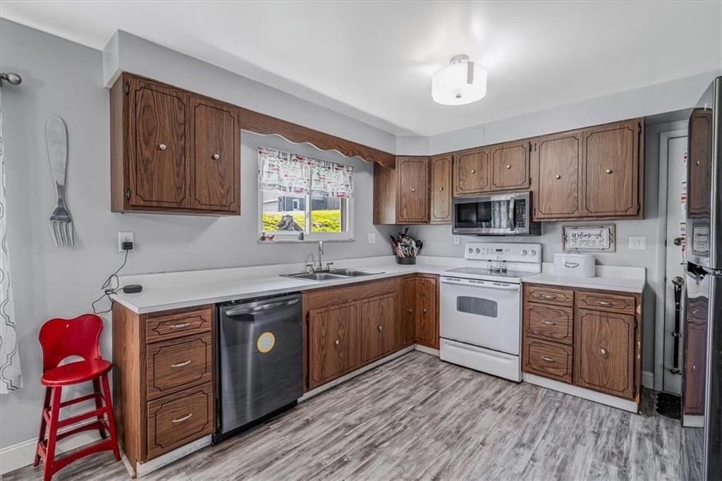 360 Jo Ann Drive Monessen, PA 15062 - Photo 14 of 48 a kitchen with a sink stove and wooden cabinets