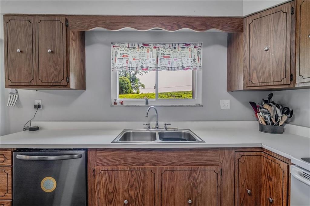 360 Jo Ann Drive Monessen, PA 15062 - Photo 15 of 48 a kitchen with stainless steel appliances granite countertop a sink a stove and a wooden cabinets