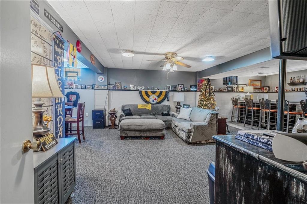 360 Jo Ann Drive Monessen, PA 15062 - Photo 34 of 48 a living room with furniture a rug and a chandelier