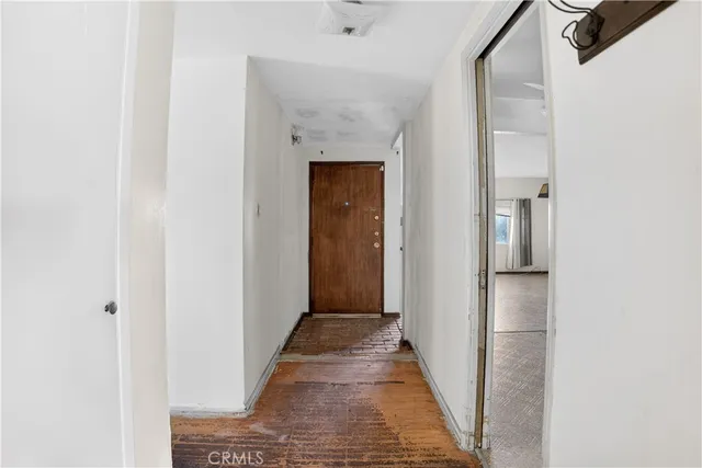 a view of a hallway with wooden floor
