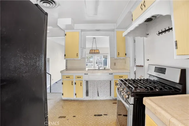 a kitchen with stainless steel appliances granite countertop a stove and a sink