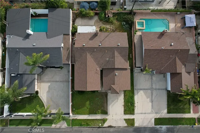 an aerial view of multiple houses with a yard