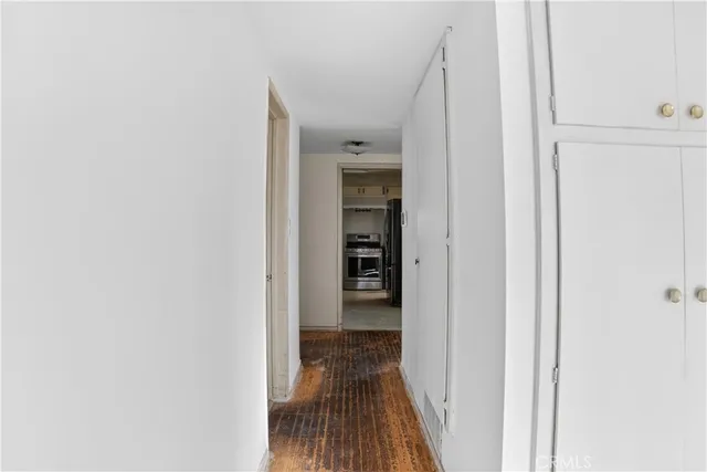 a view of a hallway with wooden floor