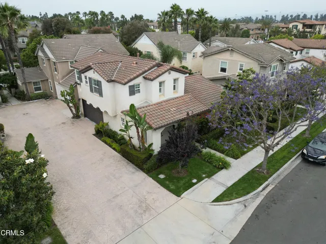 an aerial view of multiple houses with a yard