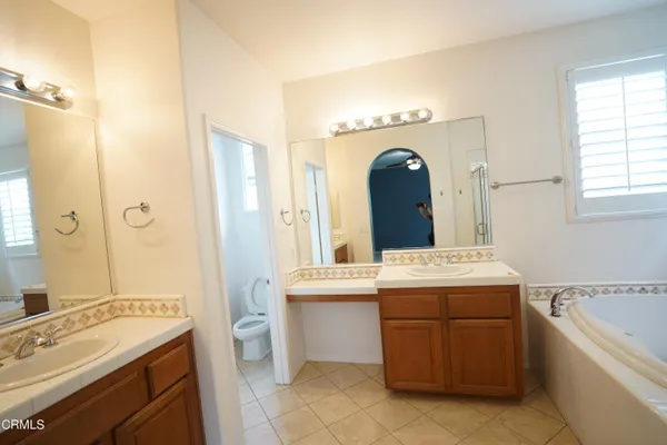 a bathroom with a sink a shower and a mirror