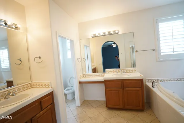 a bathroom with a sink a shower and a mirror