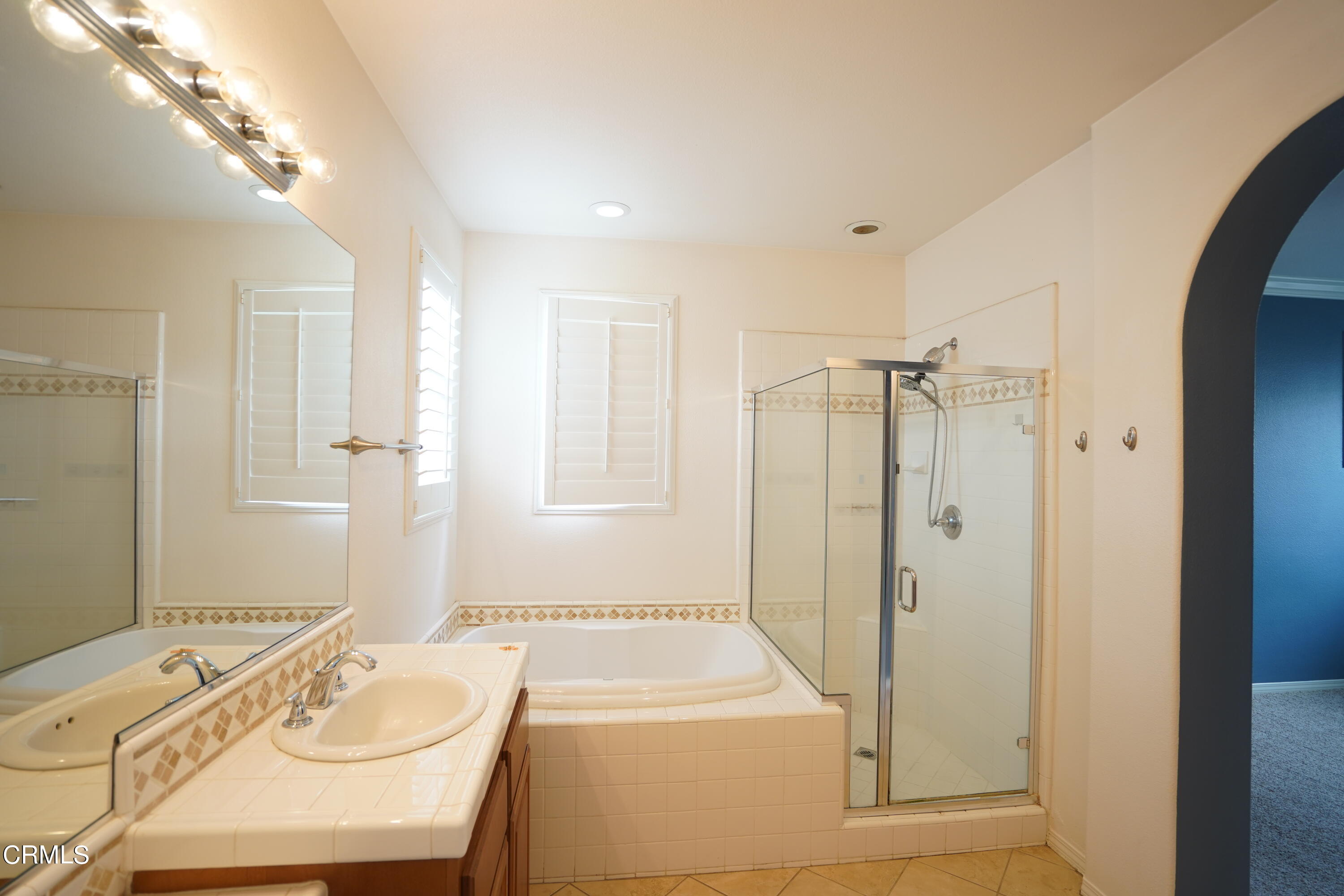 341 Spring Park Road Camarillo, CA 93012 - Photo 16 of 43 a bathroom with a tub a sink a mirror and a shower