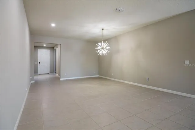 a view of a chandelier fan and entryway