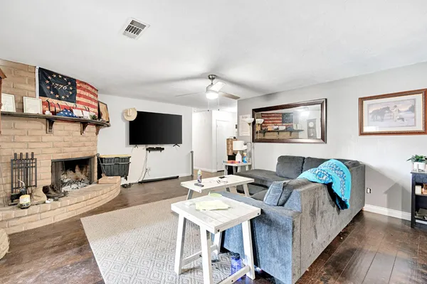 a living room with furniture a flat screen tv and a fireplace