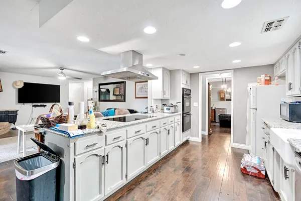 a kitchen with stainless steel appliances granite countertop a sink and cabinets