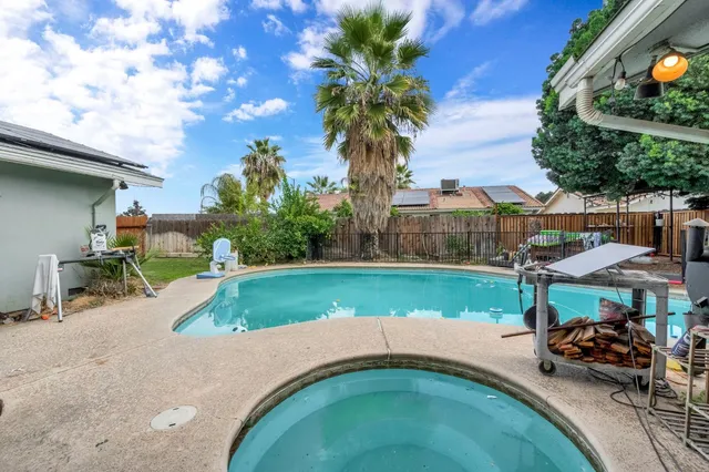 a backyard of a house with table and chairs