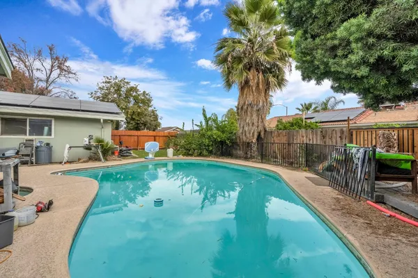a view of a house with swimming pool having outdoor seating