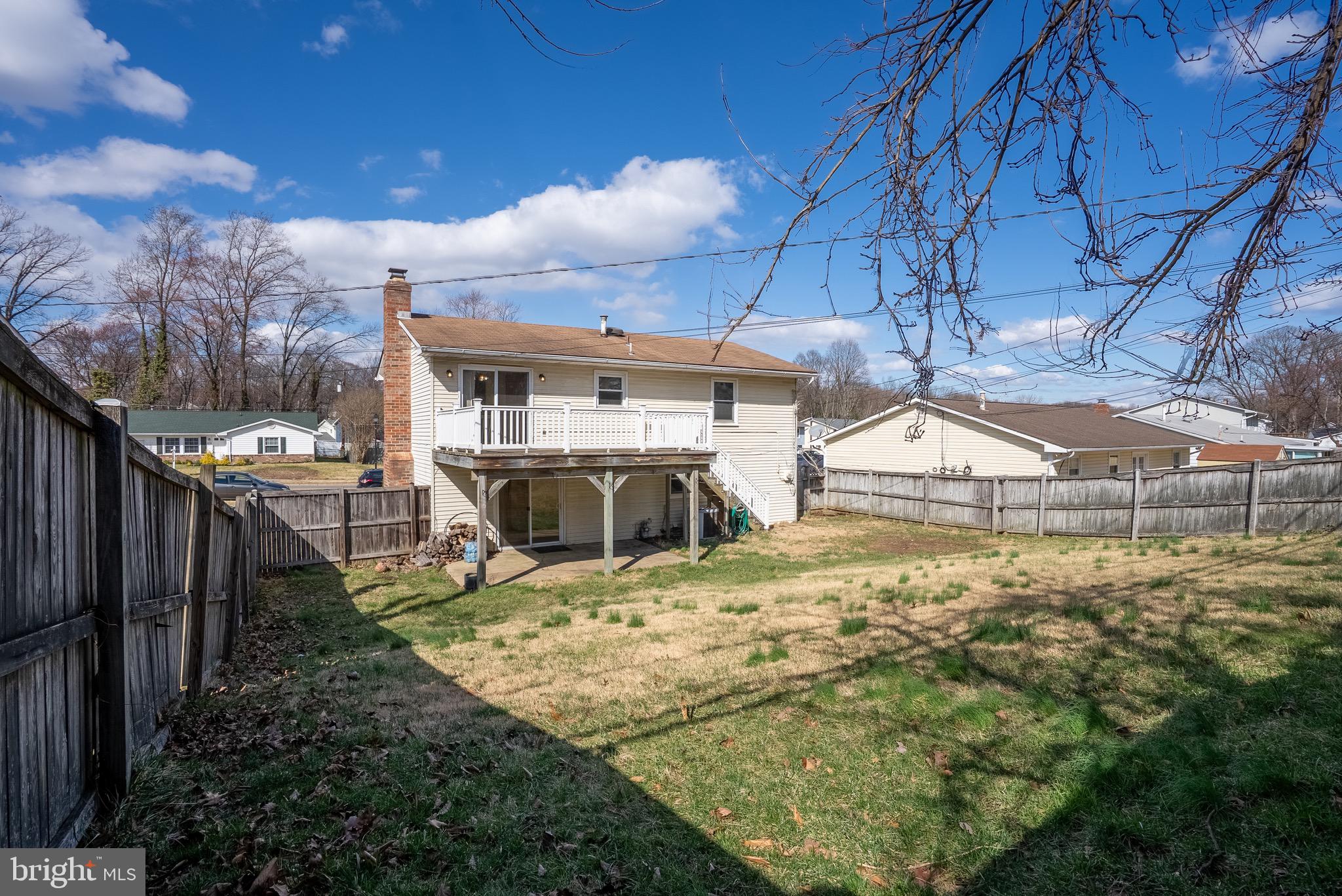 2275 Dairy Farm Road Gambrills, MD 21054 - Photo 50 of 57 a view of a backyard with table and chairs under an umbrella