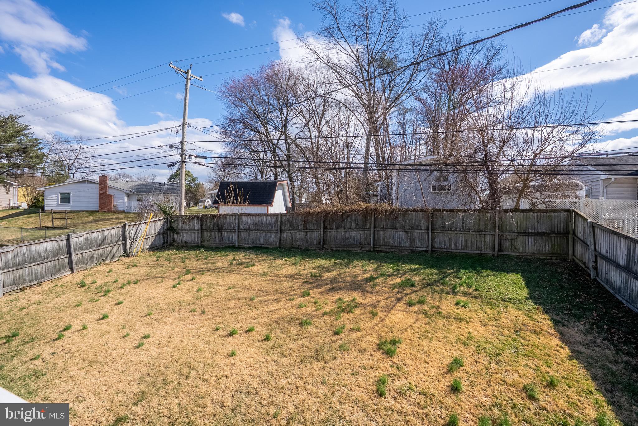 2275 Dairy Farm Road Gambrills, MD 21054 - Photo 54 of 57 a view of a backyard with plants and wooden fence