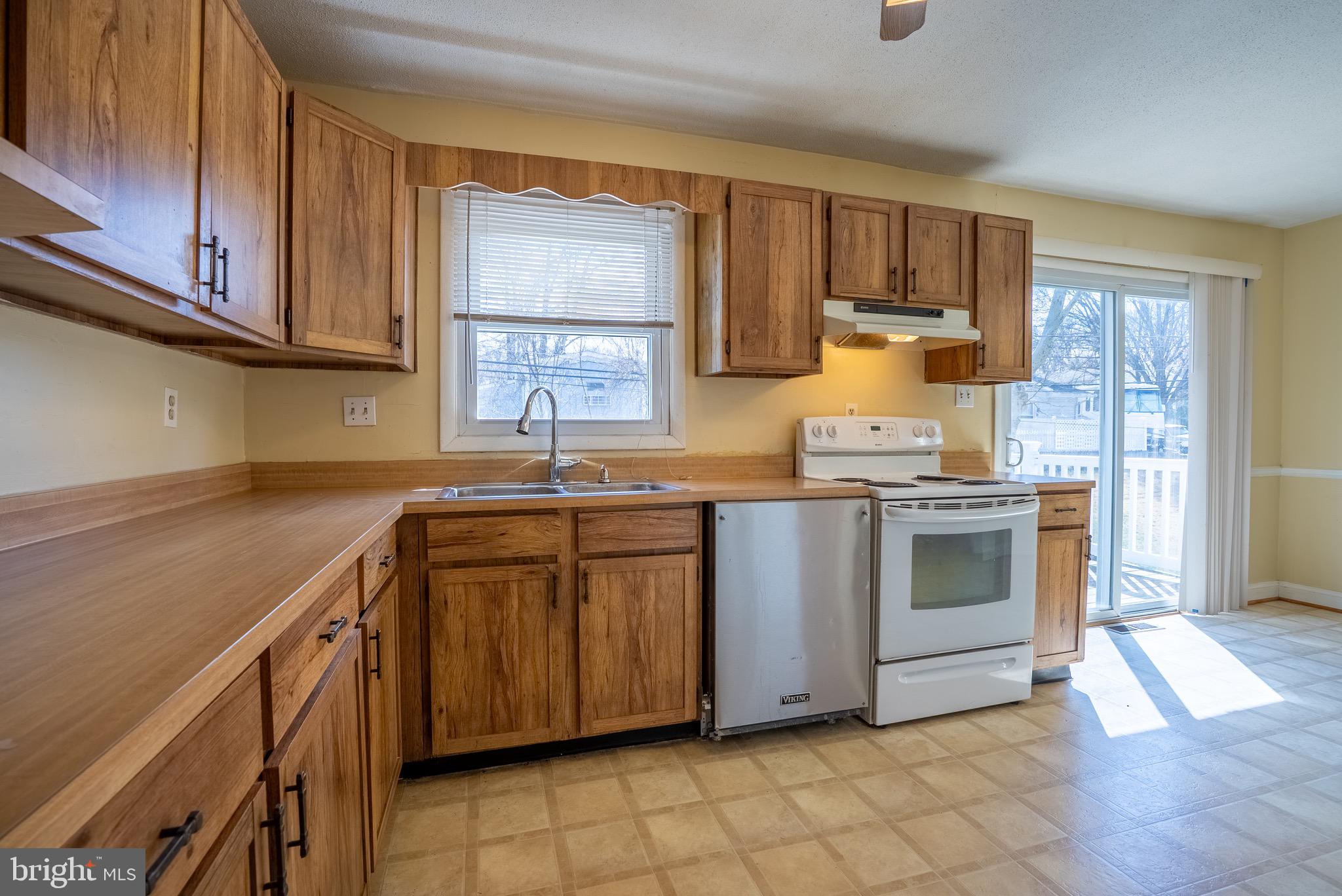 2275 Dairy Farm Road Gambrills, MD 21054 - Photo 9 of 57 a kitchen with granite countertop cabinets stainless steel appliances a sink and a window